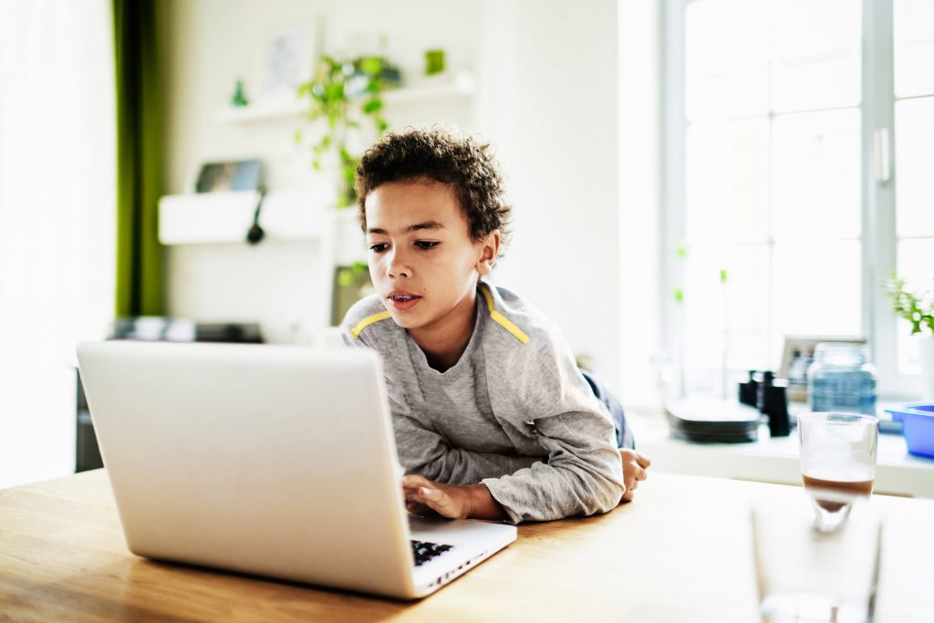 young child working on laptop