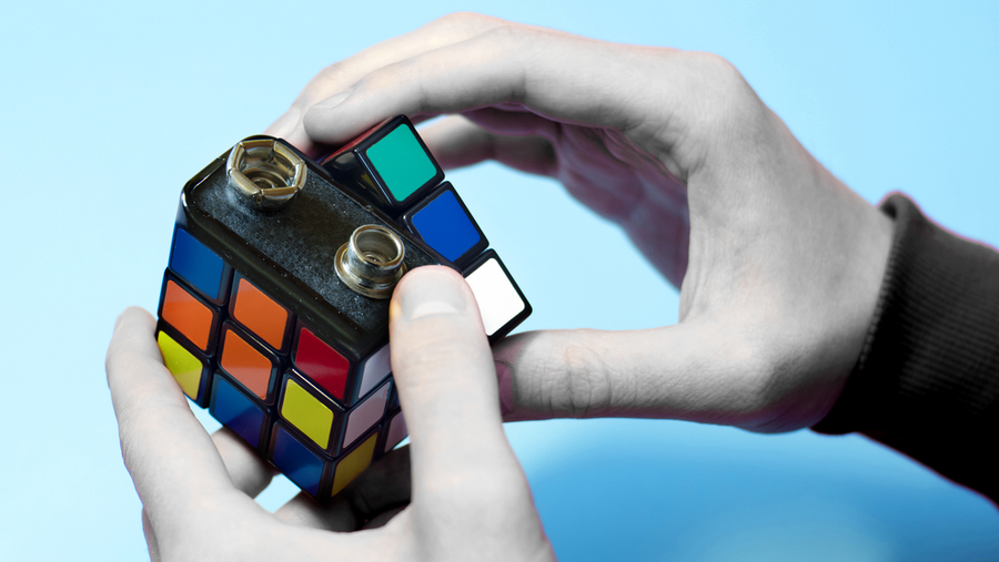 stock image of a battery merged with a Rubik's Cube, implying an energy puzzle