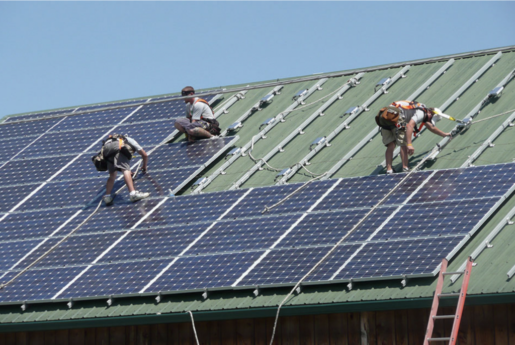 people installing solar panels on a roof